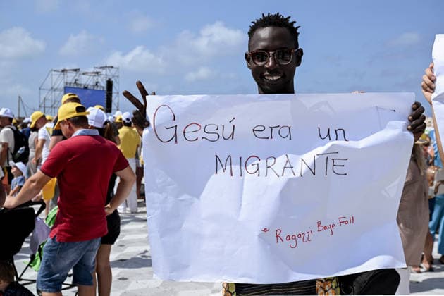 Pope Leo XIV visits the Southern Italian island of Lampedusa LAMPEDUSA, ITALY - JULY 04: A boy of African origin with a placard quoting Jesus was a migrant in Lampedusa, Italy, on July 04, 2026. Pope Leo XIV arrived in Lampedusa to rise attention to the migrant issue and the unique position of the island. During his visit he met with a group of migrants, accompanied by the Red Cross at Favaloro Pier, inaugurating a new plaque with the new name of the Pier dedicated to Pope Francis. Later nearly 4000 people gathered in the sport field to attend the homily celebrated by the Pope. Valeria Ferraro Anadolu Lampedusa Italy. Editorial use only. Please get in touch for any other usage.  Copyright: x2026xAnadoluxValeriaxFerrarox