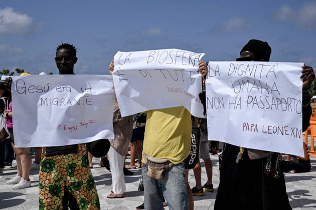 Pope Leo XIV visits the Southern Italian island of Lampedusa LAMPEDUSA, ITALY - JULY 04: Boys from Palermo Baye Fall with placards asking dignity and respect for migrants in Lampedusa, Italy, on July 04, 2026. Pope Leo XIV arrived in Lampedusa to rise attention to the migrant issue and the unique position of the island. During his visit he met with a group of migrants, accompanied by the Red Cross at Favaloro Pier, inaugurating a new plaque with the new name of the Pier dedicated to Pope Francis. Later nearly 4000 people gathered in the sport field to attend the homily celebrated by the Pope. Valeria Ferraro Anadolu Lampedusa Italy. Editorial use only. Please get in touch for any other usage.  Copyright: x2026xAnadoluxValeriaxFerrarox