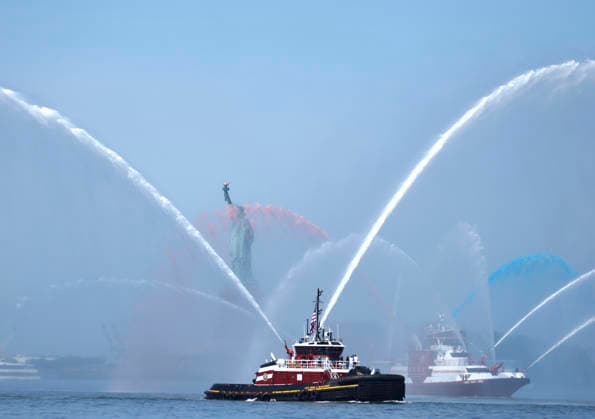 New York City Fire Department boats spray red, white and blue water in the air near the Statue of Liberty as part of Sail4th 250, a celebration for America s 250th anniversary, in New York City on Saturday, July 4, 2026. The event includes over 100 tall ships and navy vessels from more than 30 nations.  NYP20260704228 JOHNxANGELILLO