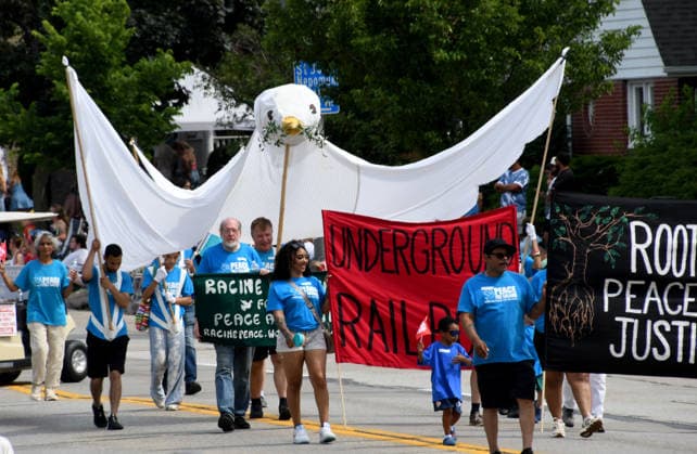 July 4, 2026, Racine, Wisconsin, USA: Holding a large piece dove banner, members of the Racine Coalition for Peace and Justice march as Racine, Wisconsin hosts its 90th annual 4th of July parade on Main Street July 4, 2026.The theme was Ã¢â‚¬oeHappy 250 America. Racine USA - ZUMAh154 20260704_znp_h154_018 Copyright: xMarkxHertzbergx