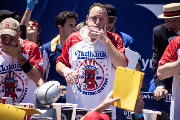 Joey Chestnut competes in the 110th Nathan s Famous Fourth of July International Hot Dog Eating Contest on Independence Day, Saturday, July 4, 2026 on Coney Island in New York City. Joey Chestnut won the championship and retains his title eating 70 hot dogs and buns.  NYP20260704804 JONATHANxFERNANDEZ