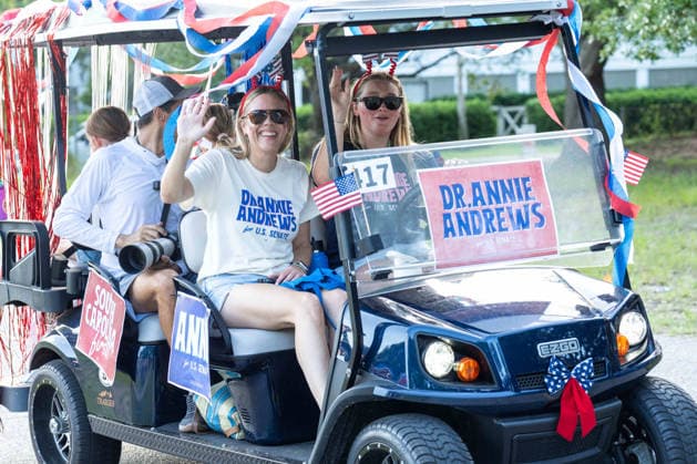 July 4, 2026, Sullivans Island, Sc, United States of America: Dr Annie Andrews, the democratic nominee for the U.S Senate race in South Carolina, waves from a golf cart float during the annual Bicycle and Golf cart parade celebrating the 250th Independence Day, July 4, 2026 in Sullivans Island, South Carolina. Like most of the nation, South Carolina is under a heat dome with dangerously hot, humid weather. Sullivans Island United States of America  - ZUMAe02_ 20260704_zaf_e02_007 Copyright: xRichardxEllisx