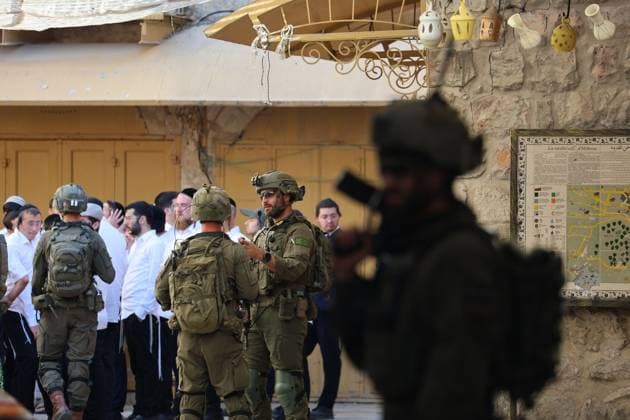 HEBRON, WEST BANK JULY 4, 2026: Israeli settlers enter the Old City of Hebron under the protection of Israeli security forces during a weekly organized visit. The visits, which take place under military escort, are opposed by many Palestinian residents and are a recurring source of tension in the city. HEBRON Palestine, State of Copyright: x xMosabxshawerx xJNAxPressx