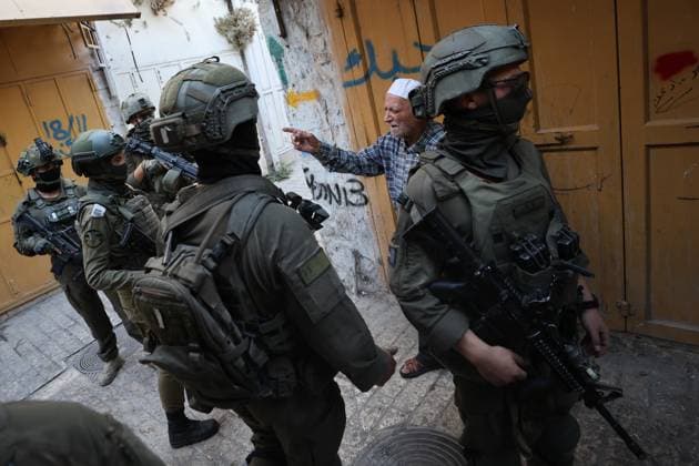 HEBRON, WEST BANK JULY 4, 2026: Israeli settlers enter the Old City of Hebron under the protection of Israeli security forces during a weekly organized visit. The visits, which take place under military escort, are opposed by many Palestinian residents and are a recurring source of tension in the city. HEBRON Palestine, State of Copyright: x xMosabxshawerx xJNAxPressx