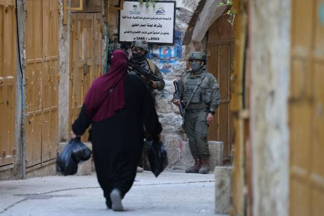 HEBRON, WEST BANK JULY 4, 2026: Israeli settlers enter the Old City of Hebron under the protection of Israeli security forces during a weekly organized visit. The visits, which take place under military escort, are opposed by many Palestinian residents and are a recurring source of tension in the city. HEBRON Palestine, State of Copyright: x xMosabxshawerx xJNAxPressx
