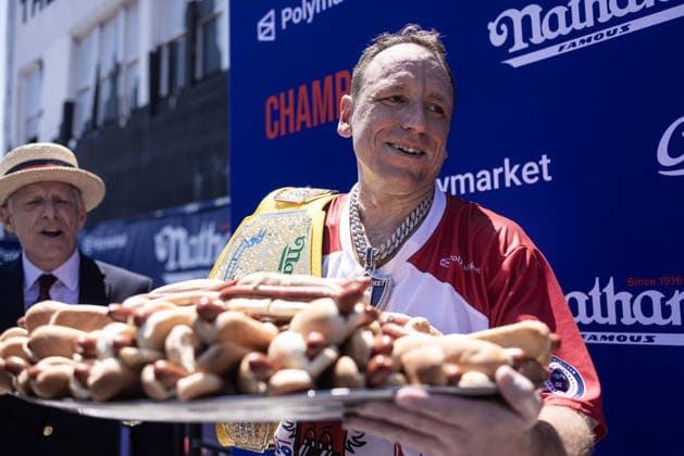 Joey Chestnut competes in the 110th Nathan s Famous Fourth of July International Hot Dog Eating Contest on Independence Day, Saturday, July 4, 2026 on Coney Island in New York City. Joey Chestnut won the championship and regains his title eating 70 hot dogs and buns.  NYP2026070480111 JONATHANxFERNANDEZ