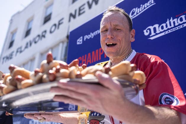 Joey Chestnut competes in the 110th Nathan s Famous Fourth of July International Hot Dog Eating Contest on Independence Day, Saturday, July 4, 2026 on Coney Island in New York City. Joey Chestnut won the championship and regains his title eating 70 hot dogs and buns.  NYP2026070480113 JONATHANxFERNANDEZ