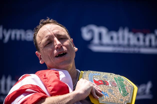 Joey Chestnut competes in the 110th Nathan s Famous Fourth of July International Hot Dog Eating Contest on Independence Day, Saturday, July 4, 2026 on Coney Island in New York City. Joey Chestnut won the championship and regains his title eating 70 hot dogs and buns.  NYP2026070480116 JONATHANxFERNANDEZ