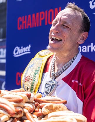 Joey Chestnut competes in the 110th Nathan s Famous Fourth of July International Hot Dog Eating Contest on Independence Day, Saturday, July 4, 2026 on Coney Island in New York City. Joey Chestnut won the championship and regains his title eating 70 hot dogs and buns.  NYP2026070480120 JONATHANxFERNANDEZ