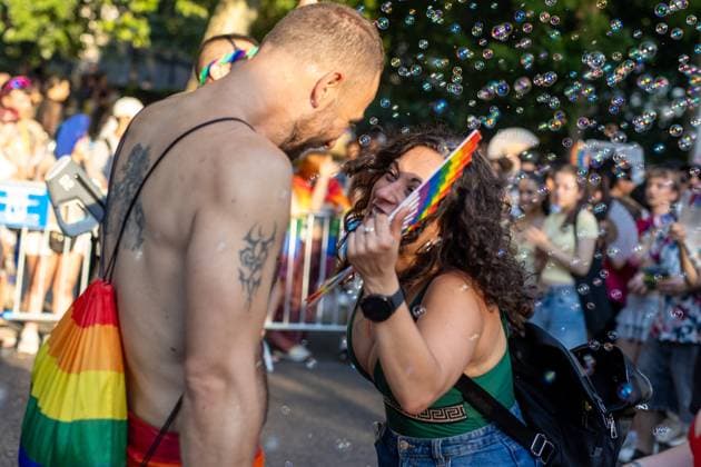 July 4, 2026, Madrid, Madrid, Spain: A couple looks at each other while she blows soap bubbles during MADO 2026 on a street in downtown Madrid..Celebration of MADO, annual LGBT Pride parade through the center of Madrid, one of the largest and most important in Europe. Madrid Spain  - ZUMAs197 20260704_aaa_s197_159 Copyright: xSOPAxImagesx