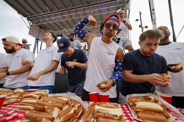 July 4, 2026, Tampa, Florida, USA: Christian Restrepo flexes while other contestants compete to a crowd of hundreds at the Where my Dogs at? Hot Dog Eating Contest at Armature Works part of the Liberty By The Bay citywide celebration on Saturday, July 4, 2026 in Tampa. Tampa USA - ZUMAs70_ 20260704_zan_s70_006 Copyright: xLuisxSantanax