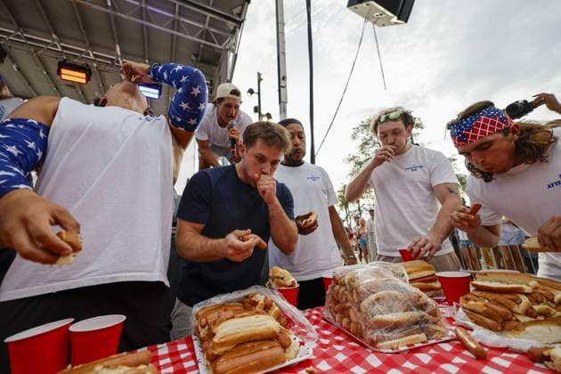 July 4, 2026, Tampa, Florida, USA: Contestants compete to a crowd of hundreds at the Where my Dogs at? Hot Dog Eating Contest at Armature Works part of the Liberty By The Bay citywide celebration on Saturday, July 4, 2026 in Tampa. Tampa USA  - ZUMAs70_ 20260704_zan_s70_007 Copyright: xLuisxSantanax