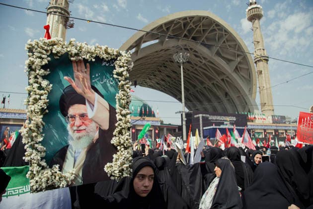 Tehran Iran Khamenei Funeral July 4 A mourner carries a framed portrait of Iran s late Supreme Leader Ayatollah Ali Khamenei decorated with flowers during his funeral ceremony in the courtyard of the Imam Khomeini Grand Mosalla in Tehran, Iran, on July 4, 2026. Ayatollah Khamenei and members of his family were killed on February 28 in a U.S.-Israeli airstrike during the first day of a military campaign against the Islamic Republic. The attack brought an end to his 36-year rule, leading to a six-day multi-city state funeral and drawing thousands of mourners to pay their final respects. Tehran Tehran Iran Copyright: xHosseinxBerisx