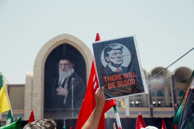 Tehran Iran Khamenei Funeral July 4 A mourner holds a poster depicting President Donald Trump with a crosshair over his face and the text THERE WILL BE BLOOD during the funeral ceremony for Iran s late Supreme Leader Ayatollah Ali Khamenei in the courtyard of the Imam Khomeini Grand Mosalla in Tehran, Iran, on July 4, 2026. Ayatollah Khamenei and members of his family were killed on February 28 in a U.S.-Israeli airstrike during the first day of a military campaign against the Islamic Republic. The attack brought an end to his 36-year rule, leading to a six-day multi-city state funeral and drawing thousands of mourners to pay their final respects. Tehran Tehran Iran Copyright: xHosseinxBerisx