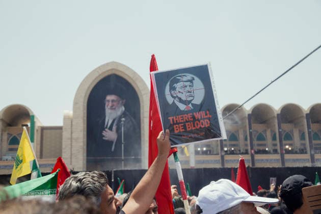 Tehran Iran Khamenei Funeral July 4 A mourner holds a poster depicting President Donald Trump with a crosshair over his face and the text THERE WILL BE BLOOD during the funeral ceremony for Iran s late Supreme Leader Ayatollah Ali Khamenei in the courtyard of the Imam Khomeini Grand Mosalla in Tehran, Iran, on July 4, 2026. Ayatollah Khamenei and members of his family were killed on February 28 in a U.S.-Israeli airstrike during the first day of a military campaign against the Islamic Republic. The attack brought an end to his 36-year rule, leading to a six-day multi-city state funeral and drawing thousands of mourners to pay their final respects. Tehran Tehran Iran Copyright: xHosseinxBerisx