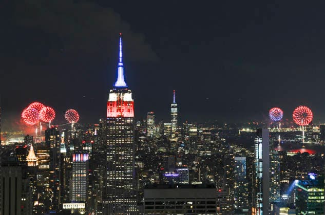 The Empire State Building is lit in red, white and blue as the Macy s 4th of July fireworks light up the night sky as part of the celebration of America s 250th anniversary as seen From the Top of the Rock Observation Deck at Rockefeller Center in New York City on Saturday, July 4, 2026.  NYP20260704959 JOHNxANGELILLO