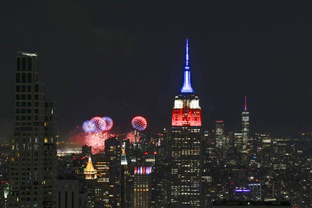 The Empire State Building is lit in red, white and blue as the Macy s 4th of July fireworks light up the night sky as part of the celebration of America s 250th anniversary as seen From the Top of the Rock Observation Deck at Rockefeller Center in New York City on Saturday, July 4, 2026.  NYP20260704963 JOHNxANGELILLO
