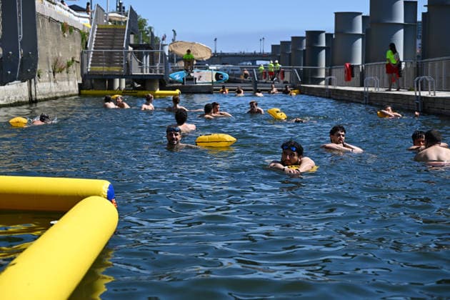 (260705) -- PARIS, July 5, 2026 -- People swim in the Seine River, Paris, France, on July 4, 2026. Paris opened some swimming sites in the Seine River to help people escape heat on Saturday. (Photo by Xinhua) FRANCE-PARIS-SEINE RIVER-SWIMMING-OPEN EmmaxDaxSilva 