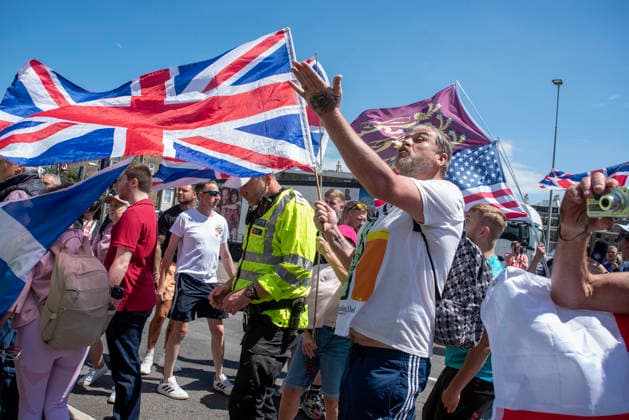 July 4, 2026, Dover, United Kingdom: A far-right protester makes gesture to the antifascists during a demonstration in Dover. Around 100-120 supporters of the Pink Ladies gathered from across the country in Dover, UK. The Pink Ladies is an anti immigration far-right movement. The far-right activists marched through central Dover to the Immigration Centre and they were confronted by a small group of antifascist counter-protesters during their march. Dover United Kingdom  - ZUMAs197 20260704_aaa_s197_230 Copyright: xKrisztianxElekx