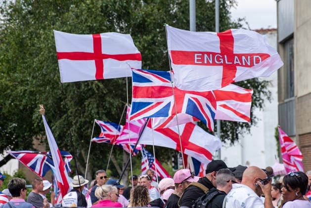 July 4, 2026, Dover, United Kingdom: St George s flags and Union Jacks flies outside the Golden Lion pub before a demonstration in Dover. Around 100-120 supporters of the Pink Ladies gathered from across the country in Dover, UK. The Pink Ladies is an anti immigration far-right movement. The far-right activists marched through central Dover to the Immigration Centre and they were confronted by a small group of antifascist counter-protesters during their march. Dover United Kingdom  - ZUMAs197 20260704_aaa_s197_231 Copyright: xKrisztianxElekx