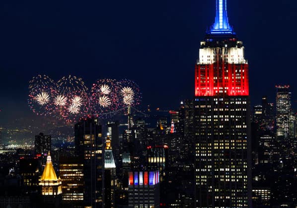 The Empire State Building is lit in red, white and blue as the Macy s 4th of July fireworks light up the night sky as part of the celebration of America s 250th anniversary as seen From the Top of the Rock Observation Deck at Rockefeller Center in New York City on Saturday, July 4, 2026.  NYP202607045002 JOHNxANGELILLO