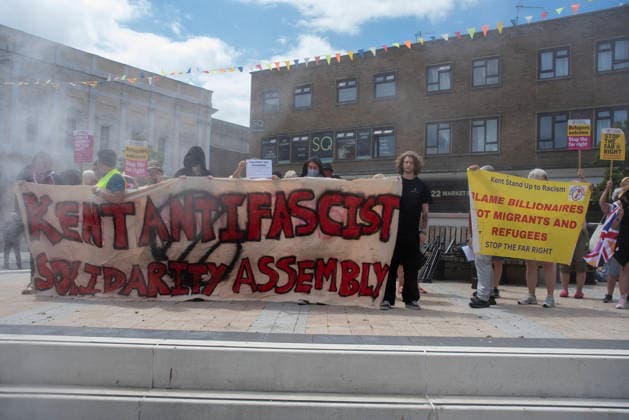 July 4, 2026, Dover, United Kingdom: Antifascist counter-protesters hold banners and placards during a demonstration in Dover. Around 100-120 supporters of the Pink Ladies gathered from across the country in Dover, UK. The Pink Ladies is an anti immigration far-right movement. The far-right activists marched through central Dover to the Immigration Centre and they were confronted by a small group of antifascist counter-protesters during their march. Dover United Kingdom - ZUMAs197 20260704_aaa_s197_214 Copyright: xKrisztianxElekx