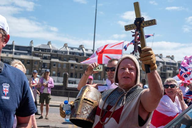 July 4, 2026, Dover, United Kingdom: A far-right protester dressed as a crusader holds up a cross during a demonstration in Dover. Around 100-120 supporters of the Pink Ladies gathered from across the country in Dover, UK. The Pink Ladies is an anti immigration far-right movement. The far-right activists marched through central Dover to the Immigration Centre and they were confronted by a small group of antifascist counter-protesters during their march. Dover United Kingdom - ZUMAs197 20260704_aaa_s197_215 Copyright: xKrisztianxElekx
