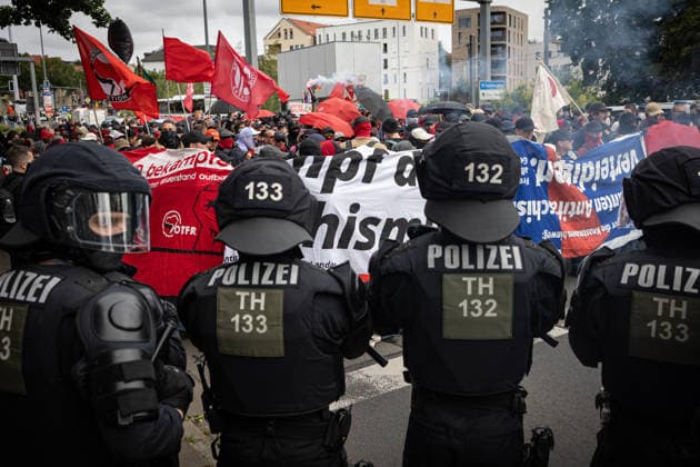 July 4, 2026, Erfurt, Germany: Police officers watch protesters holding placards during the demonstration against the federal party conference of the Alternative for Germany (AfD). The party™s two-day convention is being held at the Erfurt Exhibition Centre on July 4 5. According to police, around 31,000 people took part in the protests, while organizers estimated attendance at about 50,000. Demonstrators held marches, rallies and blockades of several access roads, including a section of the A71 motorway. Erfurt Germany - ZUMAs197 20260704_aaa_s197_258 Copyright: xVasilyxKrestyaninovx