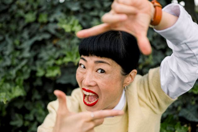 Expressive portrait of smiling woman making a playful gesture outdoors model released, Symbolfoto, FLMZF02042