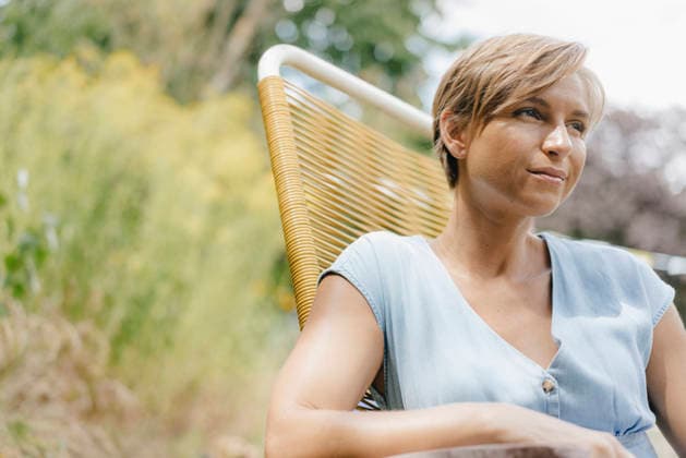 Portrait of woman sitting in garden on chair model released, Symbolfoto property released, KNSF05064