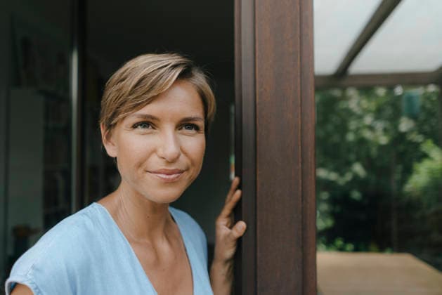 Portrait of confident woman at French window model released, Symbolfoto property released, KNSF05074