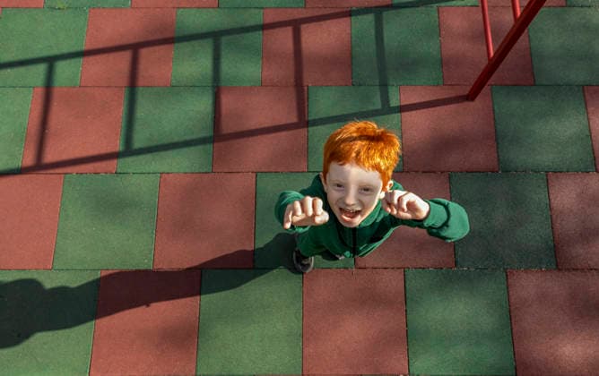 A happy red-haired boy reaches his hands toward the camera model released, Symbolfoto, MBLF01278