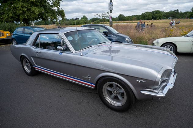 July 5, 2026, London, United Kingdom: A silver 1960s silver Ford Mustang, driven along a British suburban road. The Southside Hustle Car Meet is held on Wimbledon Common in Southwest London every first Sunday of the month. This free community event attracts owners of classic cars, supercars, sports cars, and rare or modified vehicles. Car enthusiasts, photographers, and families gather to admire an impressive variety of cars, meet like-minded people, and enjoy the welcoming atmosphere in the scenic surroundings of Wimbledon Common. London United Kingdom  - ZUMAs197 20260705_aab_s197_003 Copyright: xJamesxWilloughbyx