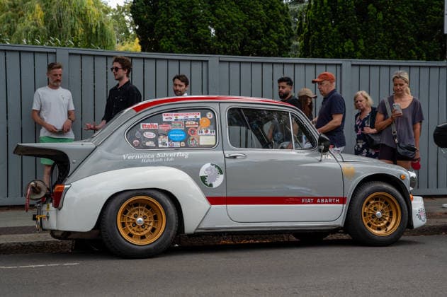 July 5, 2026, London, United Kingdom: Members of the public surround a vintage racing Fiat 500 Abath, which is parked on a British suburban road. The Southside Hustle Car Meet is held on Wimbledon Common in Southwest London every first Sunday of the month. This free community event attracts owners of classic cars, supercars, sports cars, and rare or modified vehicles. Car enthusiasts, photographers, and families gather to admire an impressive variety of cars, meet like-minded people, and enjoy the welcoming atmosphere in the scenic surroundings of Wimbledon Common. London United Kingdom  - ZUMAs197 20260705_aab_s197_008 Copyright: xJamesxWilloughbyx