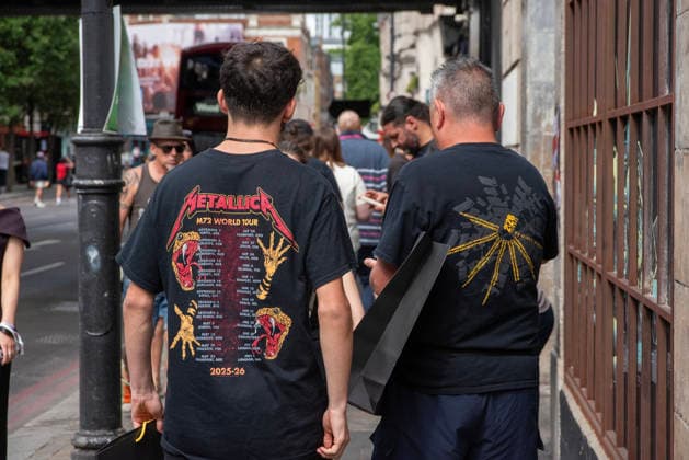 Metallica fans by the pop up ship in London, UK - 5Jul 2026 A father and a son leaves the shop after the successful shopping at the Metallica pop up shop in London. Metallica heavy metal band is having two concerts in London over the weekend as part of the M72 World Tour. Hundreds of Metallica fans were seen queuing up to buy some memorabilia by the Metallica pop up shop which is open for 4 days in London, UK. London United Kingdom Copyright: xKrisztianxElekx xSOPAxImagesx SSS_20260705_POPUP_SHOP_0011005030