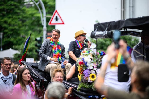 COLOGNE, GERMANY - 5 JULY, 2026: Karl Lauterbach and participants ride in a decorated horse carriage during a Pride parade in Cologne, Germany, surrounded by crowds and rainbow flags. Street Parade of the Christopher Street Day (CSD), Gay Pride. LGBT  Copyright: xx