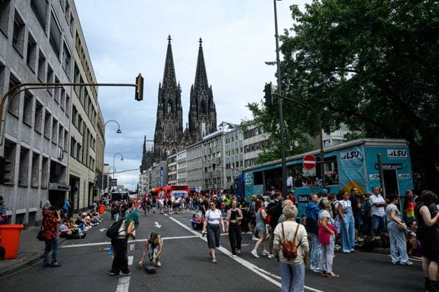 COLOGNE, GERMANY - 5 JULY, 2026: Crowds line a city street during a Pride parade with cathedral towers visible in the background. Street Parade of the Christopher Street Day (CSD), Gay Pride. LGBT  Copyright: xx