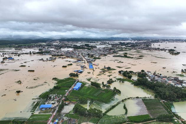 (260706) -- NANNING, July 6, 2026 -- A drone photo taken on July 6, 2026 shows the flooded downstream areas of the Liulan Reservoir after it was breached due to heavy rains in Hengzhou, Nanning City, south China s Guangxi Zhuang Autonomous Region. A severe breach occurred at a reservoir in Hengzhou, Nanning City, in south China s Guangxi Zhuang Autonomous Region on Monday morning, prompting an immediate escalation of the emergency response, local authorities said. Given the severe flood control situation, the city raised its emergency response for flood control from Level III to Level I, effective at 11:30 a.m. on Monday. The Liulan Reservoir, a medium-sized water conservancy facility in the region, reported the dam breach on Monday 