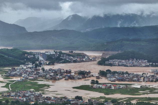 (260706) -- NANNING, July 6, 2026 -- A drone photo taken on July 6, 2026 shows the Liulan Reservoir in the distance that was breached due to heavy rains in Hengzhou, Nanning City, south China s Guangxi Zhuang Autonomous Region. A severe breach occurred at a reservoir in Hengzhou, Nanning City, in south China s Guangxi Zhuang Autonomous Region on Monday morning, prompting an immediate escalation of the emergency response, local authorities said. Given the severe flood control situation, the city raised its emergency response for flood control from Level III to Level I, effective at 11:30 a.m. on Monday. The Liulan Reservoir, a medium-sized water conservancy facility in the region, reported the dam breach on Monday morning. In respons 