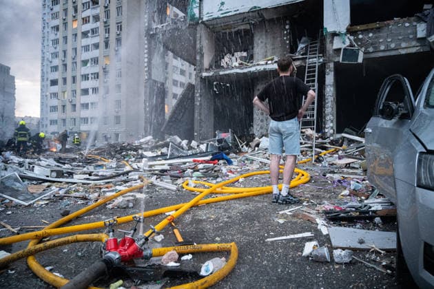 RECORD DATE NOT STATED A young man watches rescuers working at the site of a multi-storey residential building damaged in a massive combined Russian attack, Kyiv, Ukraine, on July 6, 2026. Russian forces launched a large-scale attack on the capital using ballistic and cruise missiles as well as attack drones, causing destruction to apartment buildings and civilian infrastructure across several districts of the city. The Podilskyi district suffered the most severe damage. At least 11 people were killed and 46 others were injured (Photo by Danylo Antoniuk Ukrinform) Russia launches another massive strike on Kyiv  Copyright: xDanyloxAntoniukx