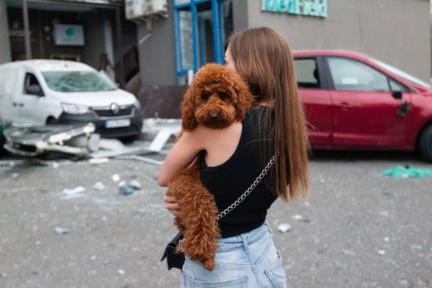 RECORD DATE NOT STATED A woman with her dog observes rescue operations following a massive combined Russian attack, Kyiv, Ukraine, on July 6, 2026. Russian forces launched a large-scale attack on the capital using ballistic and cruise missiles as well as attack drones, causing destruction to apartment buildings and civilian infrastructure across several districts of the city. The Podilskyi district suffered the most severe damage. At least 11 people were killed and 46 others were injured (Photo by Kyrylo Chubotin Ukrinform) Russia launches another massive strike on Kyiv  Copyright: xKyryloxChubotinx