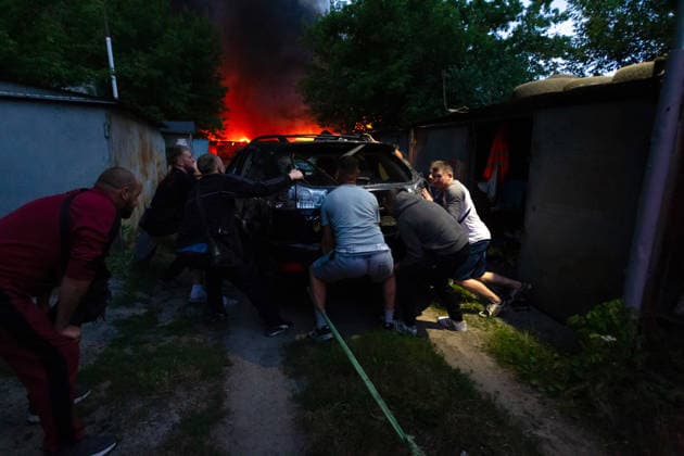 RECORD DATE NOT STATED Men push a car damaged in a massive combined Russian attack in Kyiv, Ukraine, on July 6, 2026. Russian forces launched a large-scale attack on the capital using ballistic and cruise missiles, as well as attack drones, causing extensive damage to residential buildings and civilian infrastructure in several districts of the city. The Podilskyi district was hit the hardest. At least 11 people were killed and 46 others were injured (Photo by Kyrylo Chubotin Ukrinform) Russia launches another massive strike on Kyiv  Copyright: xKyryloxChubotinx
