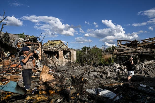 RECORD DATE NOT STATED A man takes photographs outside residential buildings damaged in a Russian guided bomb attack in Zaporizhzhia, Ukraine, on July 5, 2026. Russian forces struck the city with two guided aerial bombs. One bomb hit near a multi-storey residential building, while the other struck a private residential area. The attack damaged 35 apartments in the apartment building and destroyed private homes. More than ten people were injured, and a police officer was killed (Photo by Dmytro Smolienko Ukrinform) Russian forces strike Zaporizhzhia with two guided bombs  Copyright: xDmytroxSmolienkox