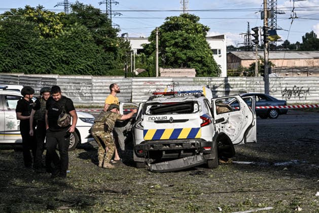 RECORD DATE NOT STATED An explosive ordnance disposal specialist inspects a police car damaged in a Russian guided bomb attack in Zaporizhzhia, Ukraine, on July 5, 2026. Russian forces struck the city with two guided aerial bombs. One bomb hit near a multi-storey residential building, while the other struck a private residential area. The attack damaged 35 apartments in the apartment building and destroyed private homes. More than ten people were injured, and a police officer was killed (Photo by Dmytro Smolienko Ukrinform) Russian forces strike Zaporizhzhia with two guided bombs  Copyright: xDmytroxSmolienkox