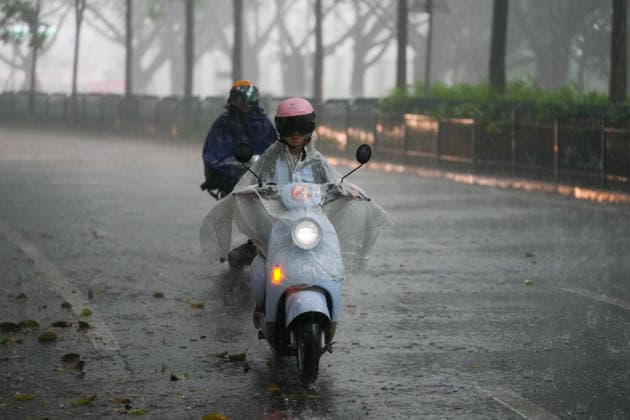 NANNING, CHINA - JULY 06: Residents ride through waterlogged streets in the rain on July 6, 2026 in Nanning, Guangxi Zhuang Autonomous Region of China. Local authorities launched a Level-IV flood emergency response as the river exceeded warning levels following heavy rainfall brought by typhoon Maysak.  Copyright: xChinaxNewsxServicex 111652649617