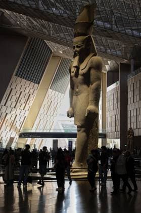 People walk past a statue of King Ramses II at the entrance of the Grand Egyptian Museum (GEM), in Giza, Egypt Cairo, Egypt July 6, 2026: The colossal statue of King Ramesses II dominates the Grand Hall of the Grand Egyptian Museum (GEM), welcoming visitors at the museum s main entrance. Standing approximately 11 meters tall and weighing around 83 tons, the red granite masterpiece dates back more than 3,200 years to Egypt s 19th Dynasty. Originally discovered in the ancient city of Memphis, the statue symbolizes the power and legacy of one of ancient Egypt s greatest pharaohs. Today, it serves as one of the Grand Egyptian Museum s most iconic landmarks, reflecting the grandeur of Egypt s rich archaeological. Giza Egypt Copyright: x xMahmoudxAhmedxabdxelghanyx xJNAxPressx
