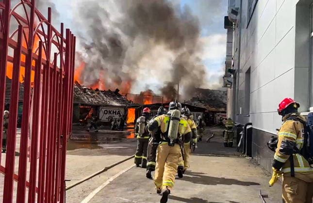 RUSSIA, IZHEVSK - JULY 7, 2026: Firefighters battle a fire at a warehouse distribution center. Video grab. Best quality available. Russia Emergencies Ministry TASS  94776601