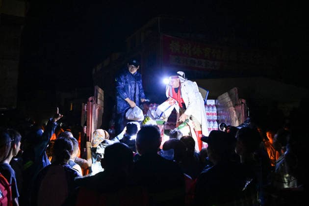 (260707) -- HENGZHOU, July 7, 2026 -- Rescuers distribute relief supplies in Hengzhou of Nanning City, south China s Guangxi Zhuang Autonomous Region, July 6, 2026. Record-breaking rainfall and the ensuing floods in parts of Nanning, capital city of south China s Guangxi Zhuang Autonomous Region, have left four people dead and eight others missing as of 10 a.m. Tuesday, according to a press conference on flood prevention and disaster relief held in Nanning. Hengzhou City and Binyang County, both currently under the jurisdiction of Nanning, recently experienced rainfall that broke local 24-hour meteorological records. The reported casualties were all in Hengzhou. ) CHINA-GUANGXI-NANNING-FLOOD-RESCUE (CN) CaoxYiming 