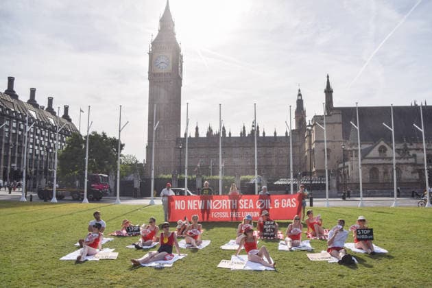 July 7, 2026, London, England, United Kingdom: Climate activists from the group Fossil Free London don swimming costumes and stage a Ã¢â‚¬Ëœsunbathe-inÃ¢â‚¬â ¢ protest dubbed Roast Against Rosebank in Parliament Square calling on the government to stop new North Sea oil and gas projects, as another heatwave hits the UK. London United Kingdom  - ZUMAv130 20260707_zip_v130_004 Copyright: xVukxValcicx