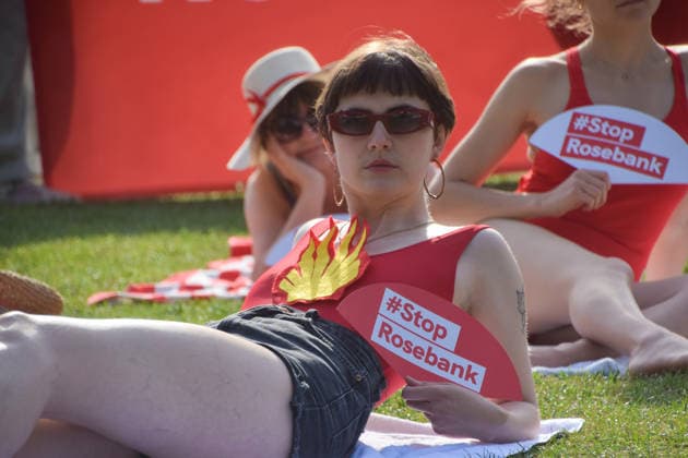 July 7, 2026, London, England, United Kingdom: Climate activists from the group Fossil Free London don swimming costumes and stage a Ã¢â‚¬Ëœsunbathe-inÃ¢â‚¬â ¢ protest dubbed Roast Against Rosebank in Parliament Square calling on the government to stop new North Sea oil and gas projects, as another heatwave hits the UK. London United Kingdom - ZUMAv130 20260707_zip_v130_009 Copyright: xVukxValcicx